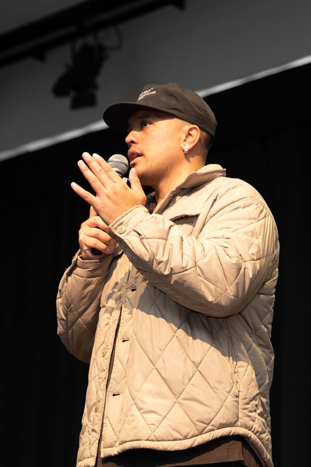 Tyrone speaking with a microphone on stage